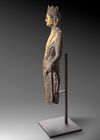 A FINELY CARVED STONE FIGURE OF A STANDING BUDDHIST DEITY