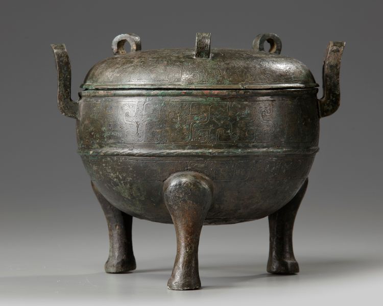 A Chinese bronze tripod ding and cover