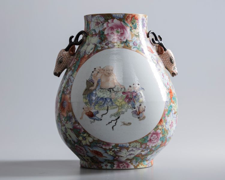 A Chinese gilt-ground famille rose millefleurs deer-head handled pear shaped vase, hu