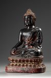 A Large Bronze Buddha Sitting on a Lotus