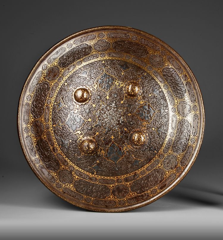 A QAJAR GOLD-DAMASCENED STEEL SHIELD,  PERSIA, 19TH CENTURY