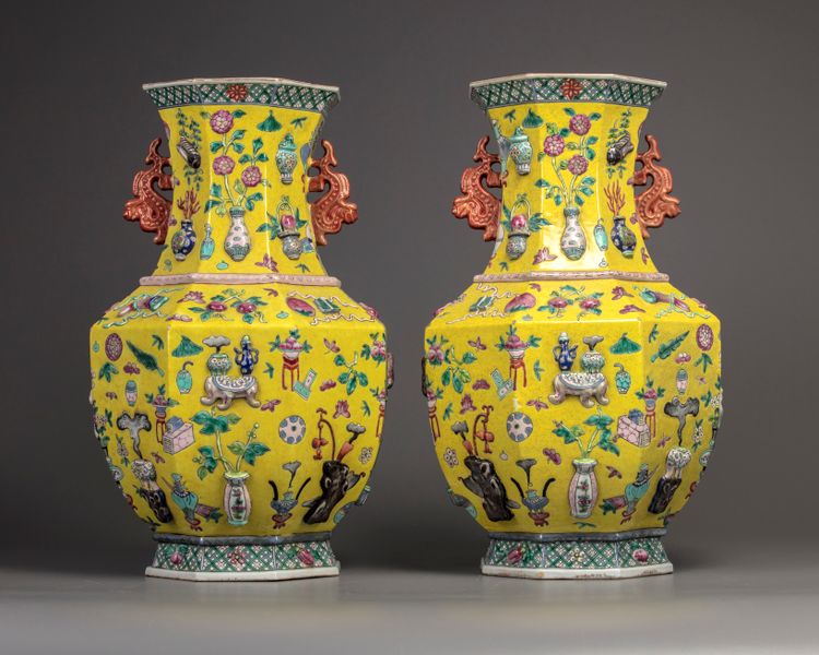 A pair of Chinese yellow-ground appliqué-decorated octagonal vases