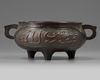 A CHINESE BRONZE 'ISLAMIC MARKET' TRIPOD CENSER, CHINA, QING DYNASTY (1644-1911)
