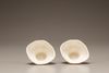 A pair of white-glazed libation cups