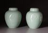A PAIR OF CHINESE CELADON-GLAZED JARS AND COVERS