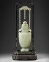 A Chinese pale celadon jade vase and cover