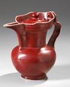 A CHINESE RUBY-RED GLAZED MONK'S CAP EWER