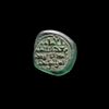 A FATIMID GLASS WEIGHT OF DIRHAM, AL-MUSTANSIR BI-ALLAH (AH 427-487 / 1036-1094 AD)