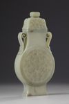 A Chinese celadon jade flattened vase and cover