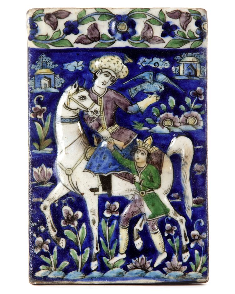 A QAJAR MOULDED POLYCHROME POTTERY TILE, PERSIA, 19TH CENTURY