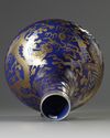 A Chinese blue-ground gilt-decorated 'dragon and phoenix' bottle vase