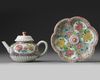 A CHINESE PINK-GROUND FAMILLE ROSE MOULDED 'CHRYSANTHEMUM' TEAPOT, COVER AND STAND