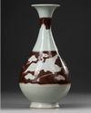 A CHINESE COPPER RED 'PHOENIX' PEAR-SHAPED VASE, YUAN DYNASTY OR LATER