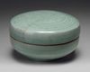 A KOREAN CELADON-GLAZED 'PHOENIX' BOX AND COVER