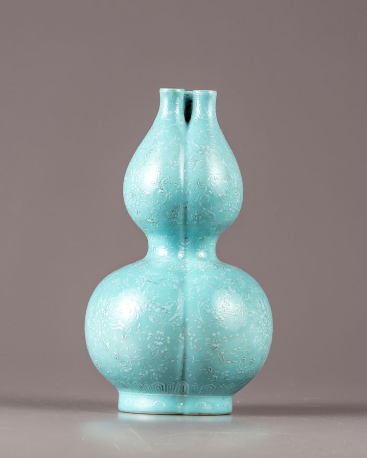 A Chinese celadon-ground white-enamel-decorated conjoined triple-neck double-gourd vase