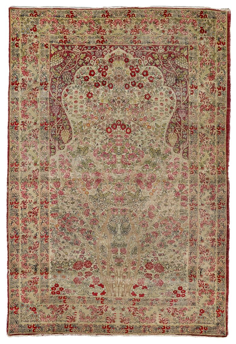 AN ANTIQUE KIRMAN PRAYER RUG